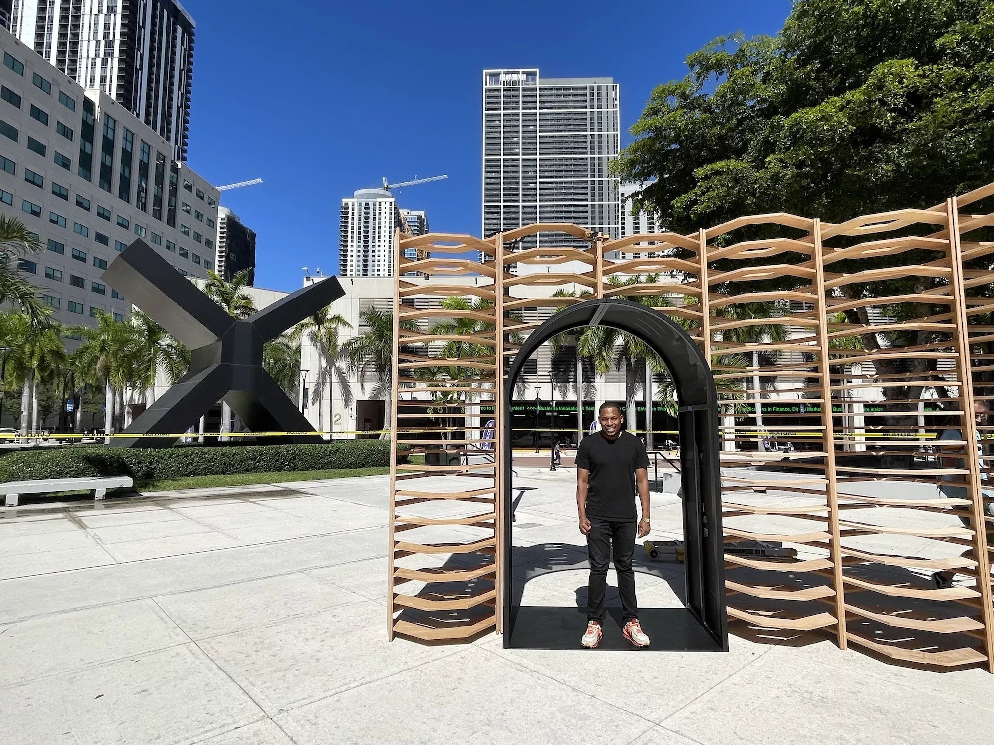 Germaine Barnes standing in front of his outdoor art installation, Ukhamba