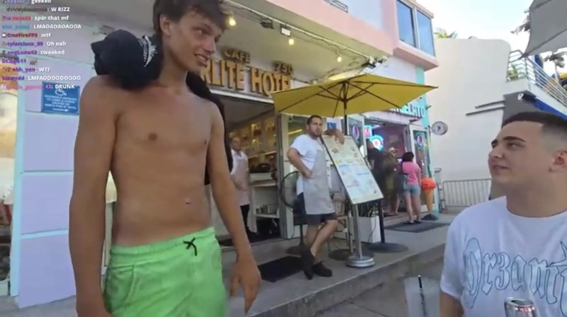 17-year-old Troy Coleman, shirtless, wearing bright green shorts