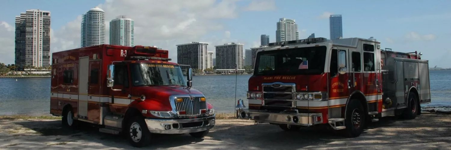 Miami Fire Rescue trucks parked near the water with the cityscape in the background