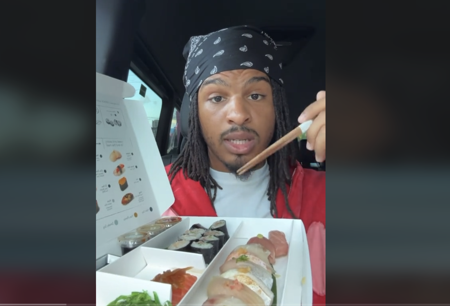 a man happily eating sushi