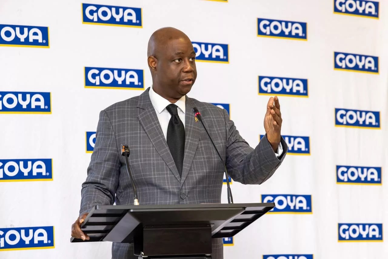 photo of a Black man at a podium with Goya Foods logos behind him