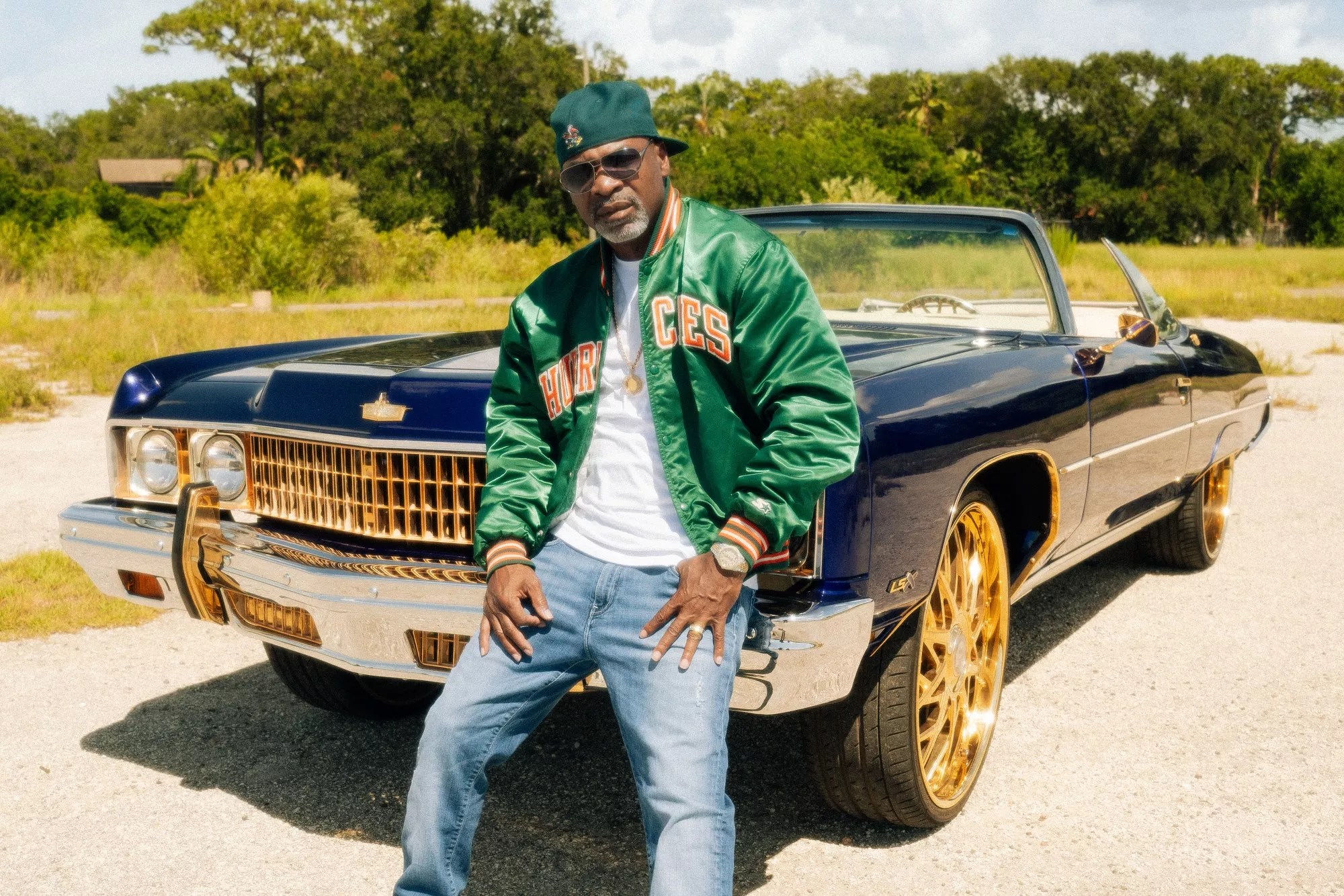 JT leaning against a car