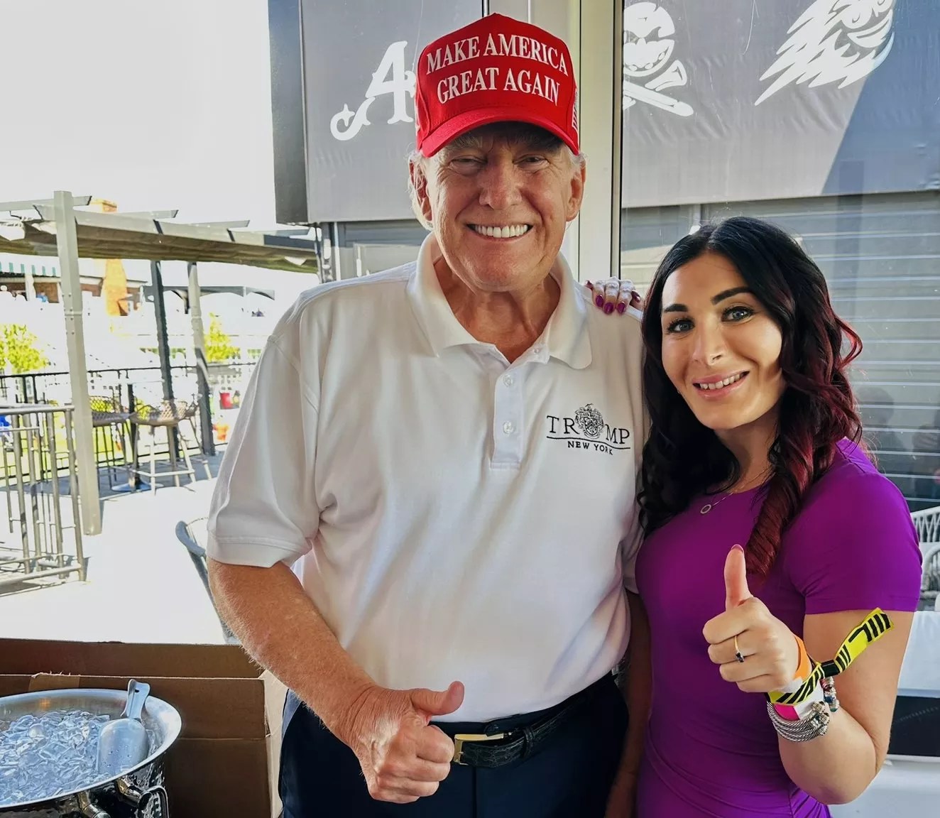 donald trump and laura loomer flash the thumbs-up sign for a photo on November 5, 2023