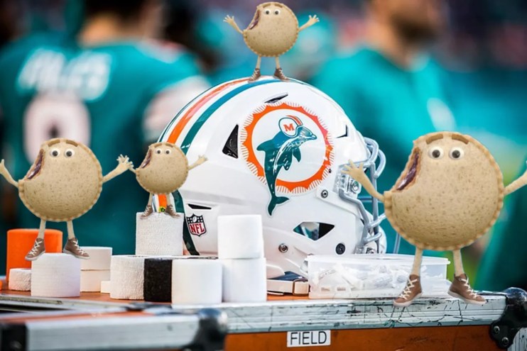 photo-illustration showing a Miami Dolphins football helmet surrounded by rolls of various types, sizes, and colors of training tape. Also Uncrustables.