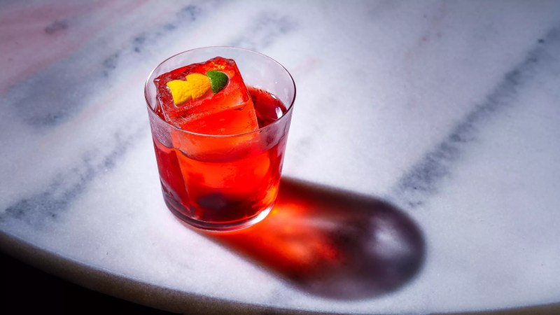a red cocktail on a white table