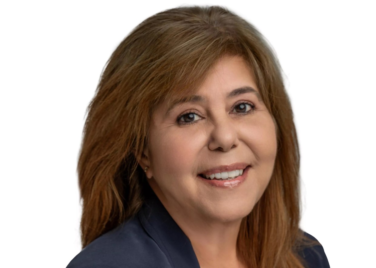 professional head shot of a smiling woman with auburn hair
