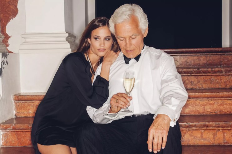 Younger woman embracing a much older man