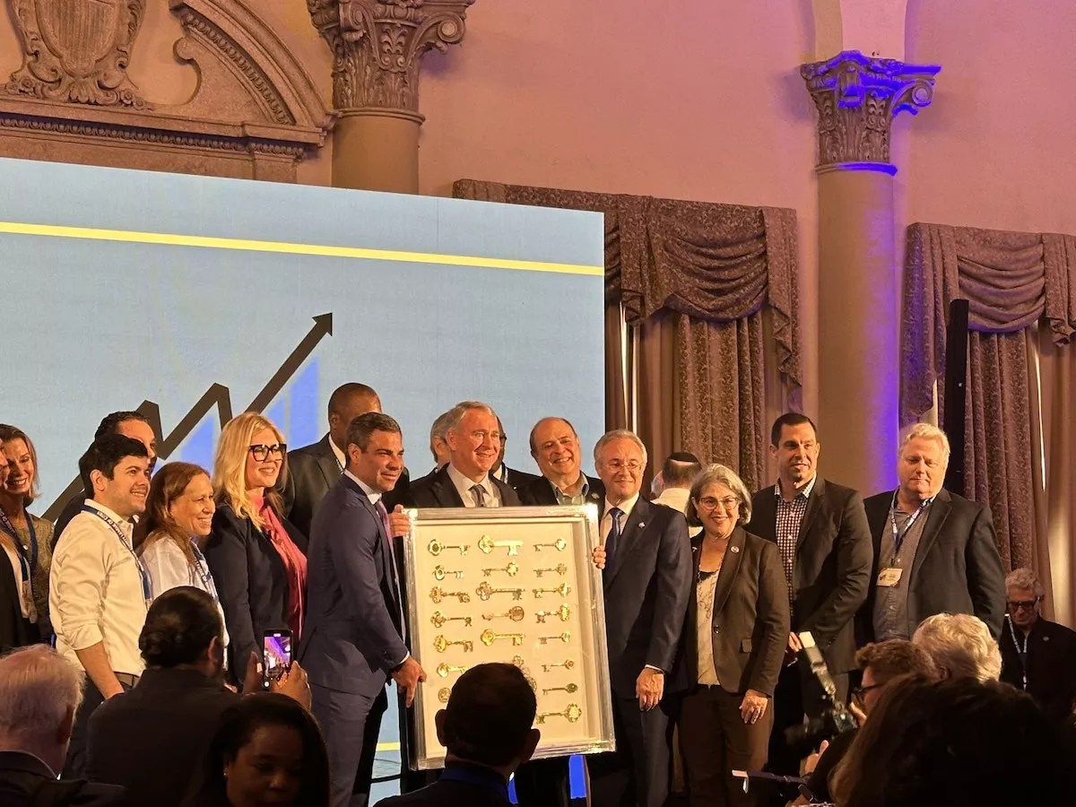 Hedge fund billionaire Ken Griffin standing alongside local leaders while being presented with honorary keys to nearly two dozen Miami-Dade cities.