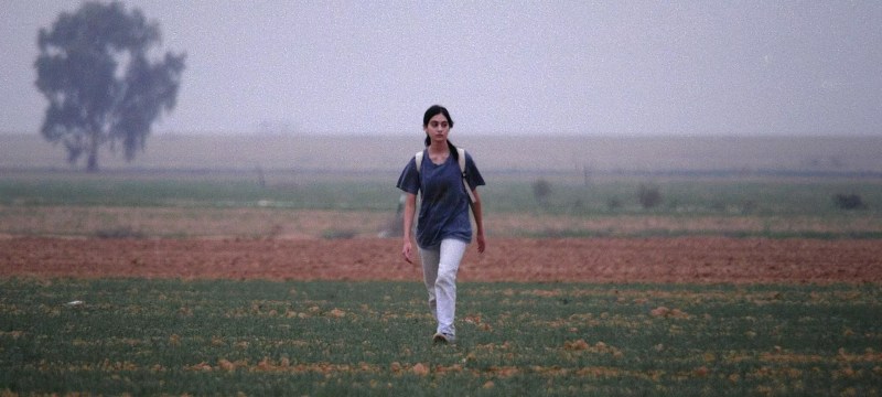 man walking in a field