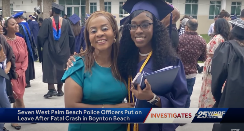 A woman stands next to her daughter, who is donning a cap and gown on graduation day.