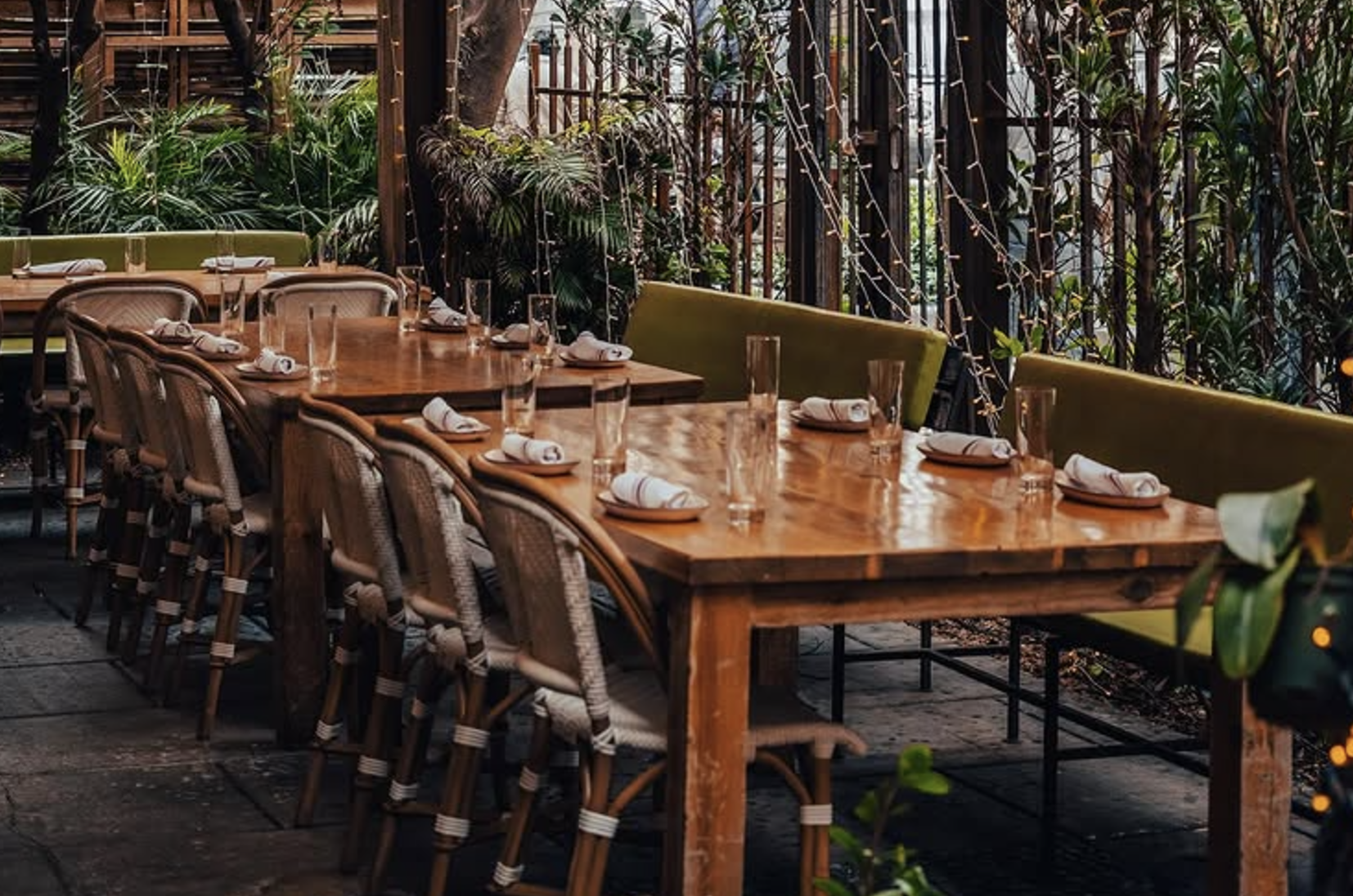an outdoor dining area with greenery