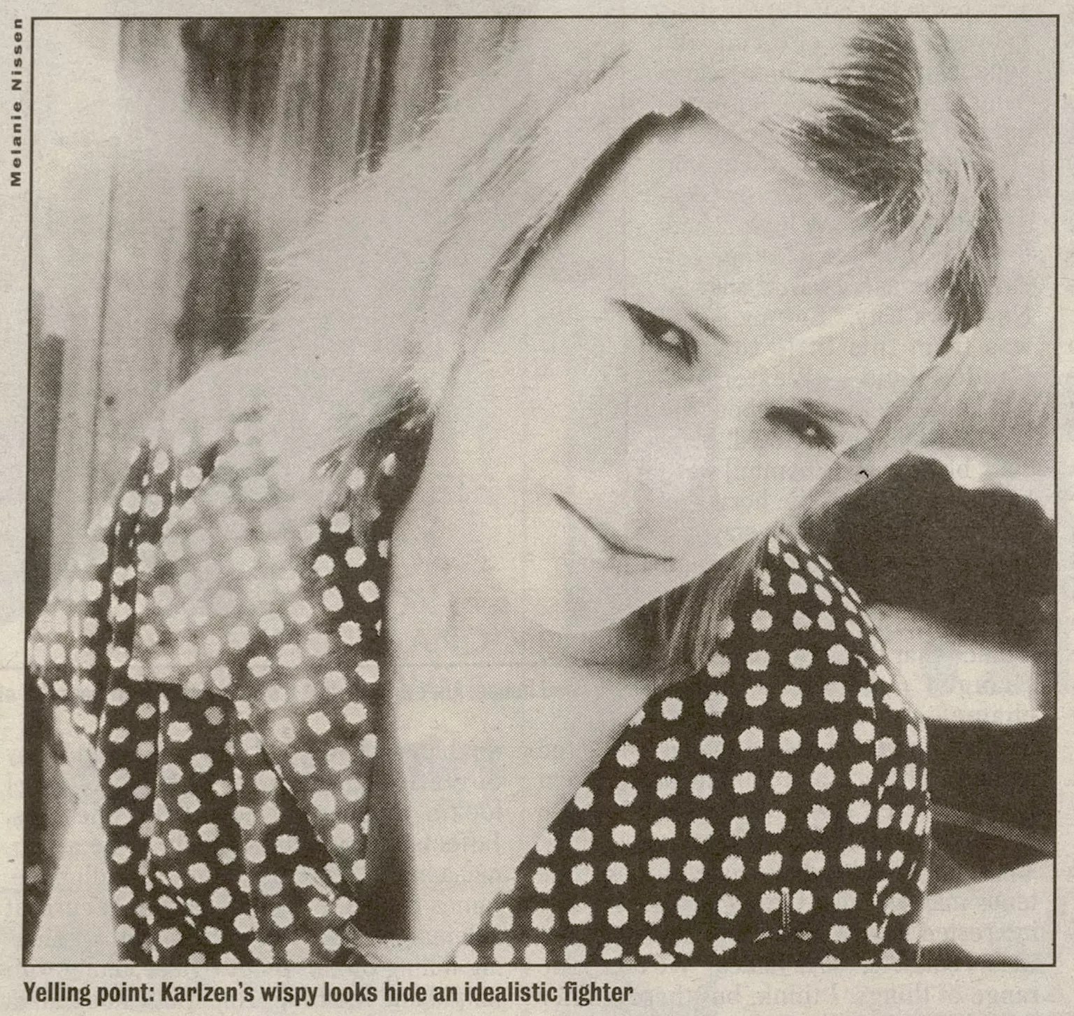 black and white close-up portrait of a woman, printed in a newspaper