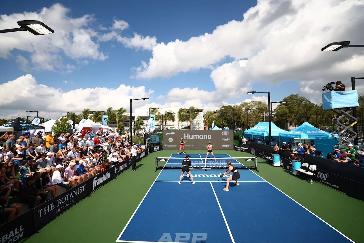 spectators watch a pickleball tournament on a sunny day