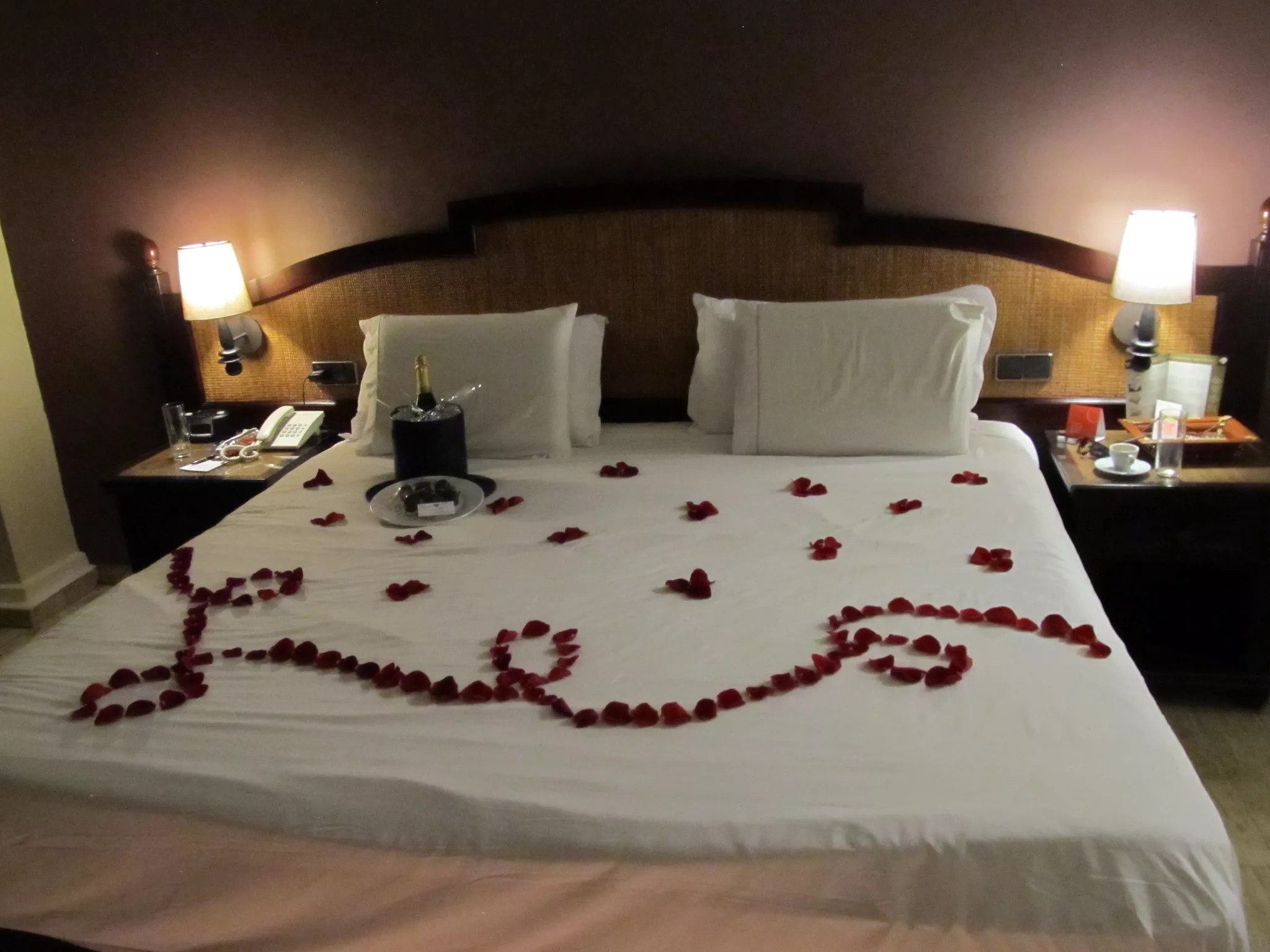 a bed covered with red rose petals
