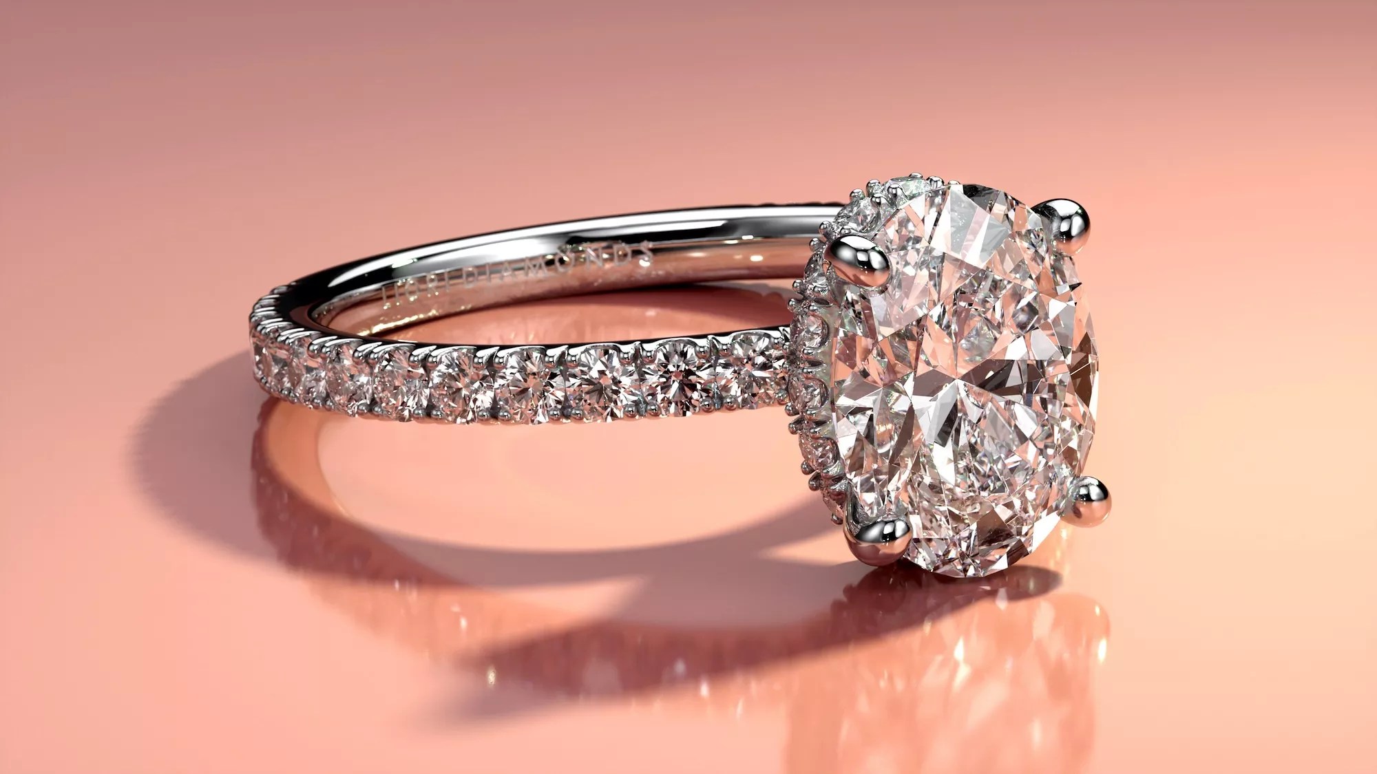close-up image of a diamond ring with a pink background