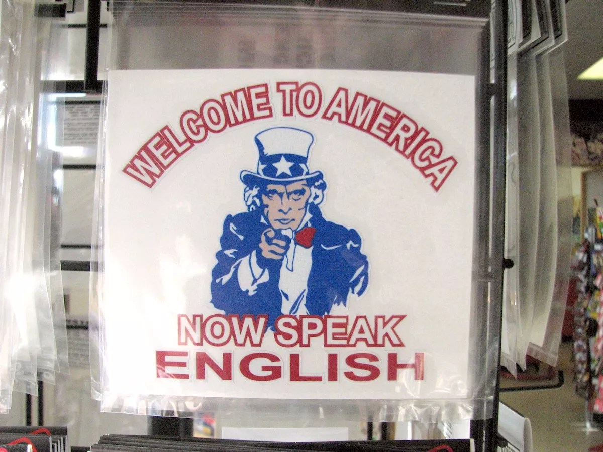 A poster showing Uncle Sam with text that reads "Welcome to America. Now Speak English"