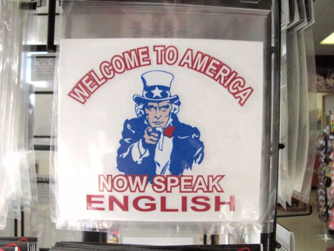 A poster showing Uncle Sam with text that reads "Welcome to America. Now Speak English"