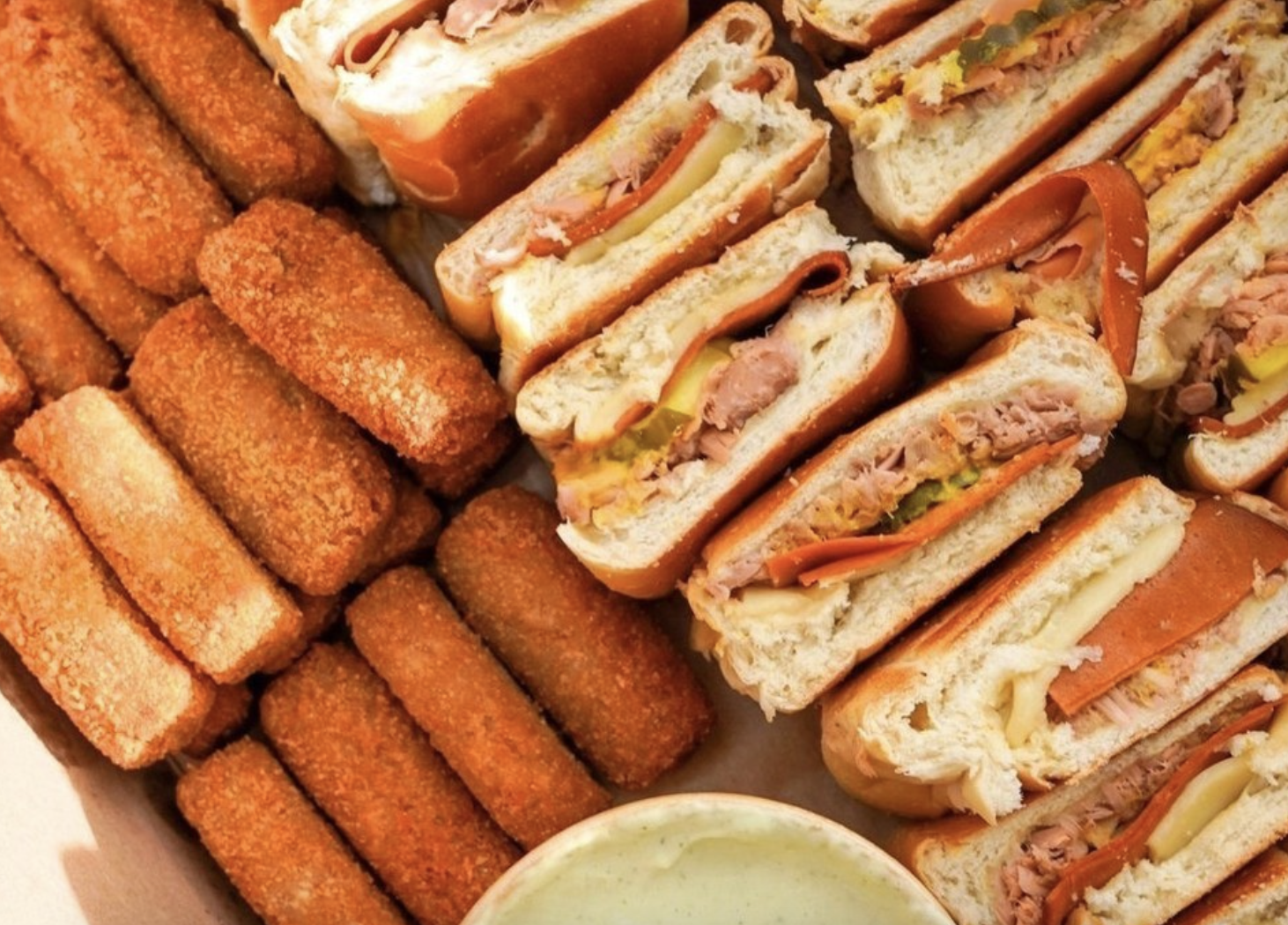 a variety of fried pastries and sandwiches