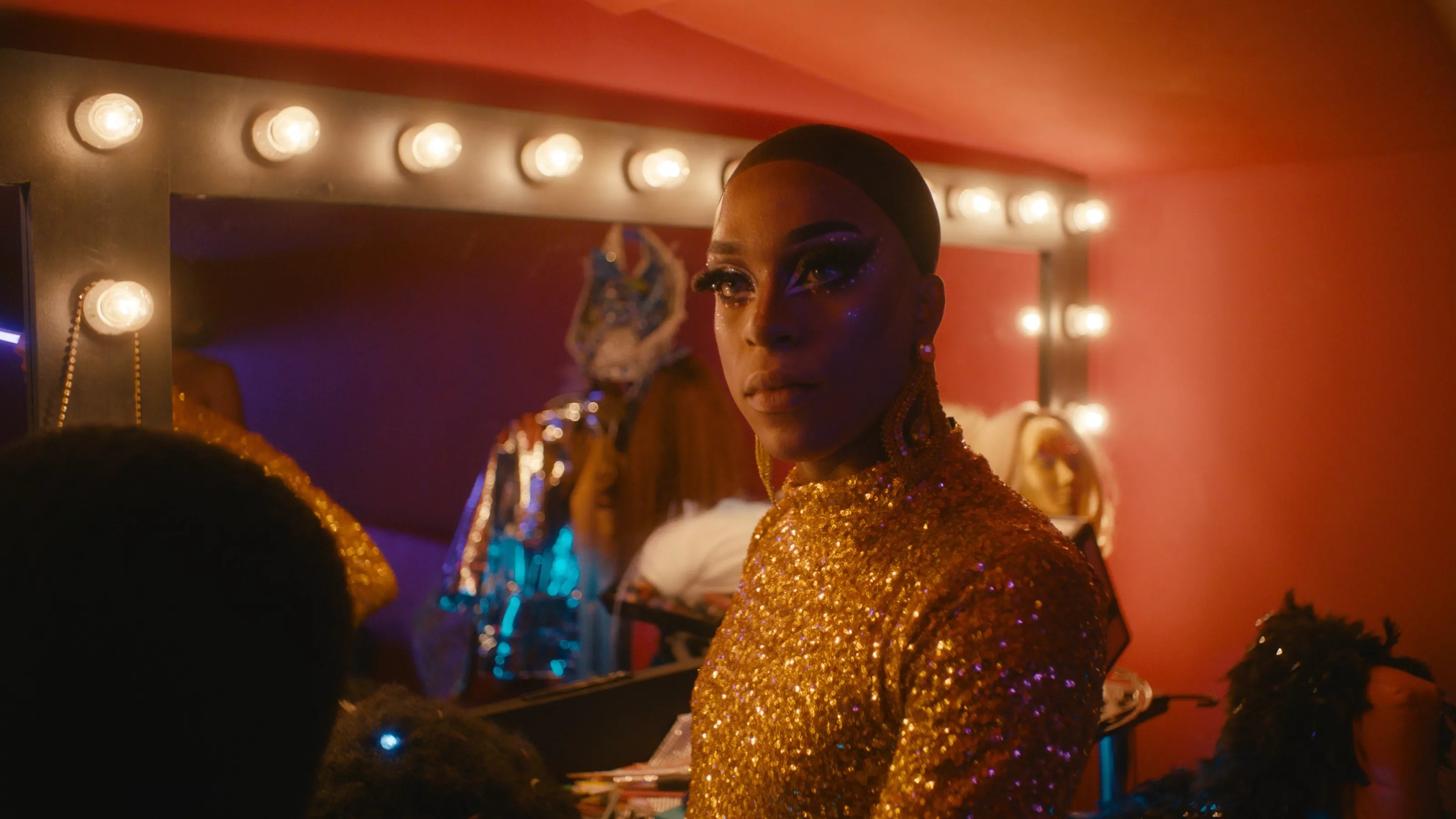 a Black drag queen in a dressing room