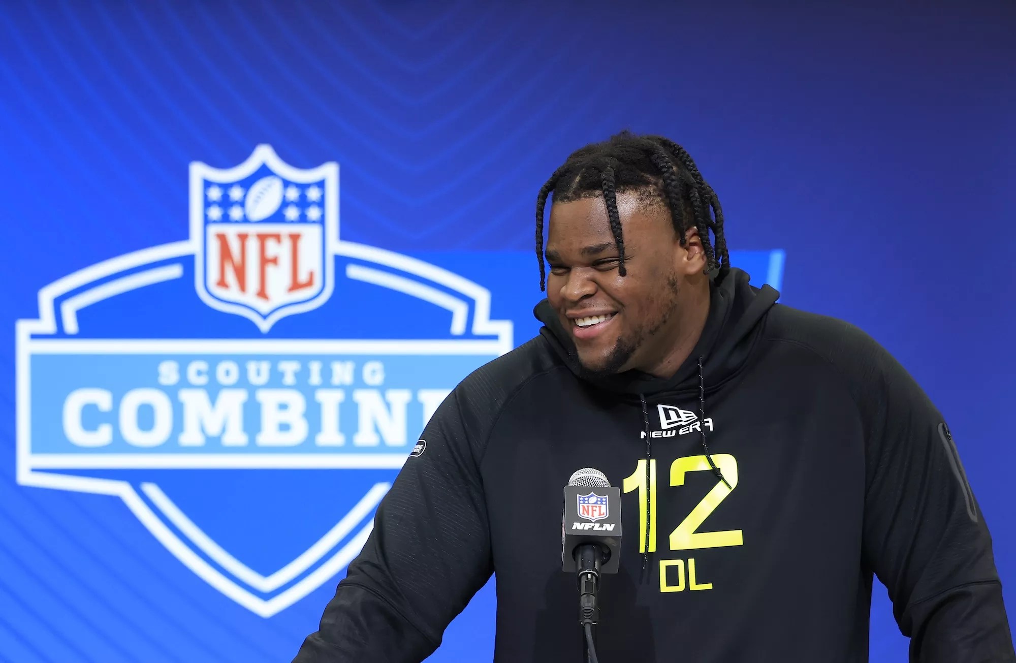 Kenneth Grant #DL12 of Michigan, dreadlocked and smiling, speaks to the media during the 2025 NFL Combine at the Indiana Convention Center on February 26, 2025