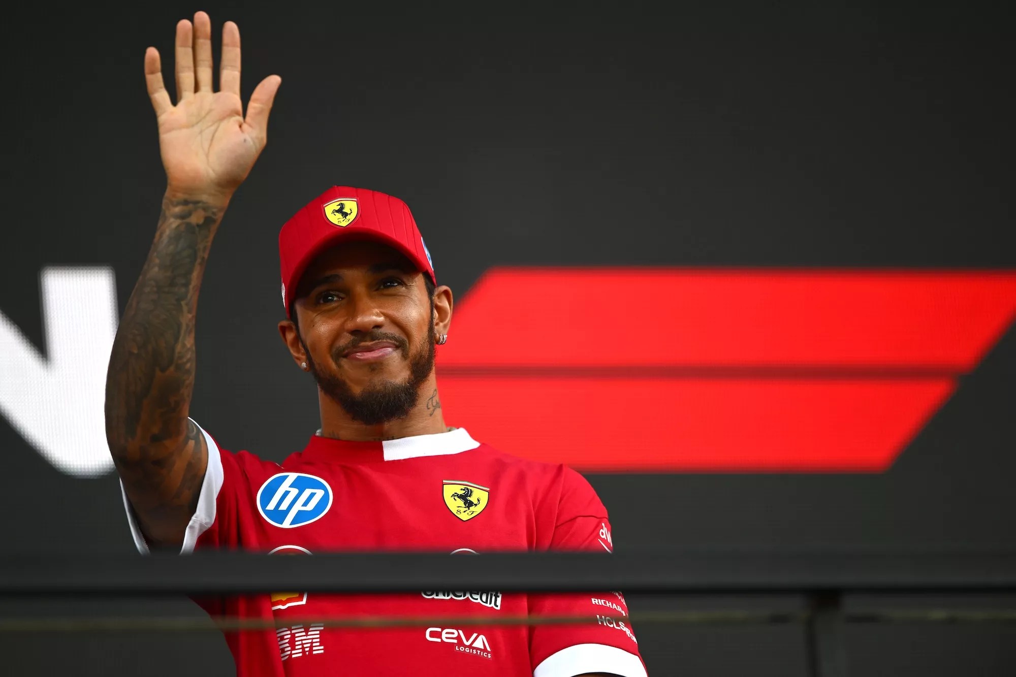 F1 driver Lewis Hamilton waves at a crowd