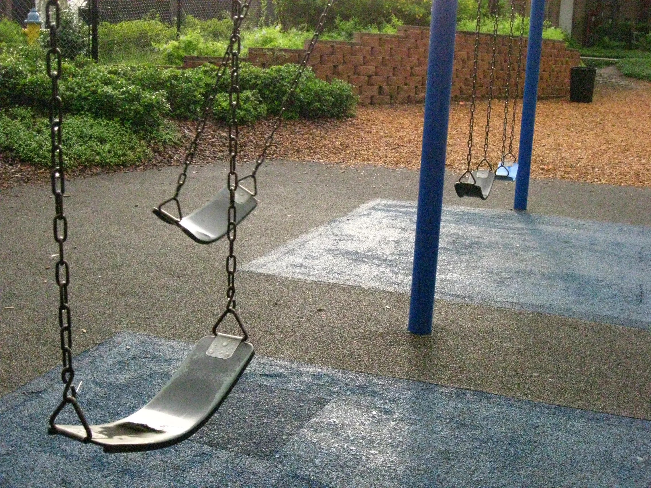 an empty swingset on a playground