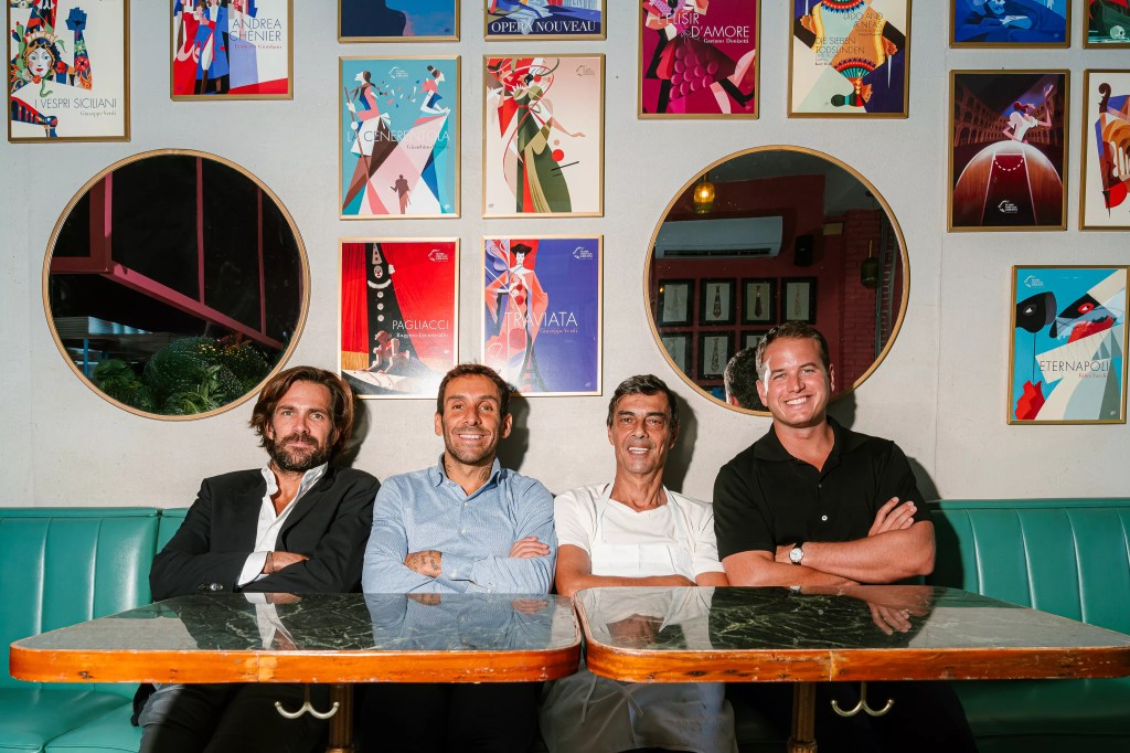 four men sitting at a table