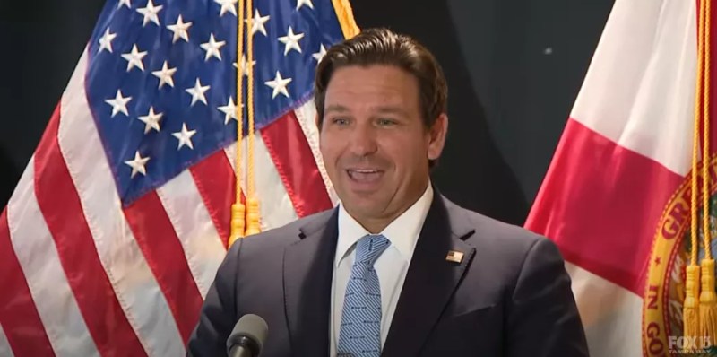 Ron DeSantis standing at a press conference