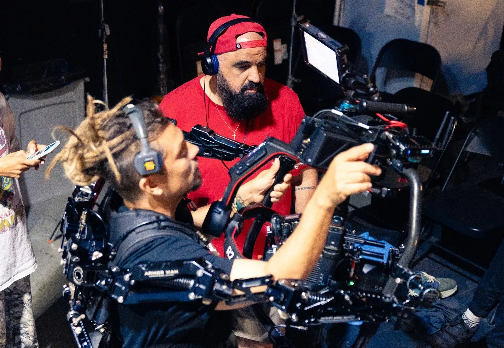 two filmmakers behind the scenes on a video shoot