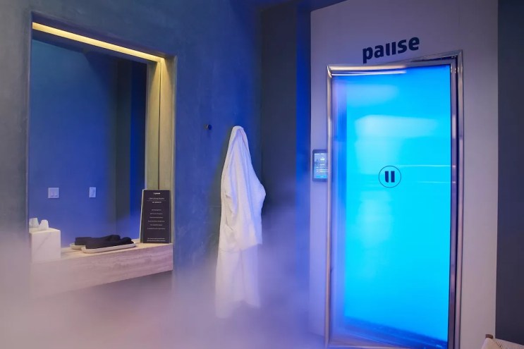 a steamy treatment room with blue lighting inside a spa