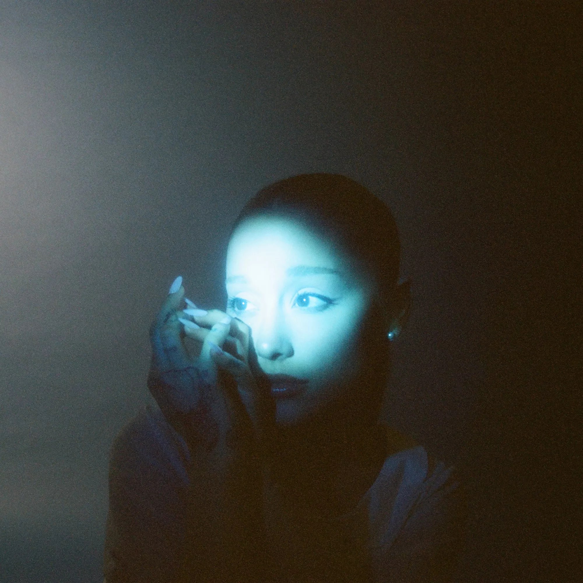 Picture of Ariana Grande under a green light.