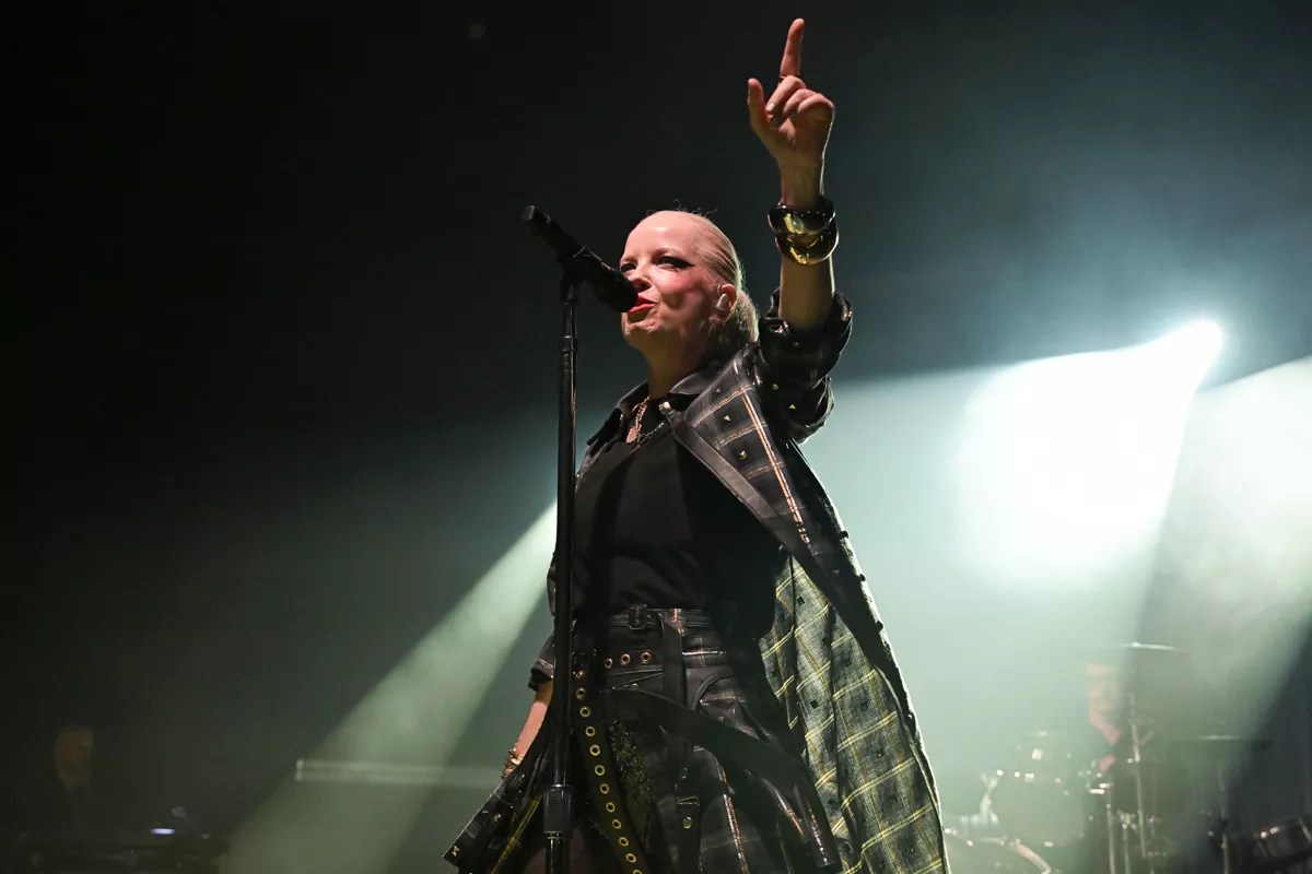 Picture of Garbage's singer Shirley Manson singing on stage.