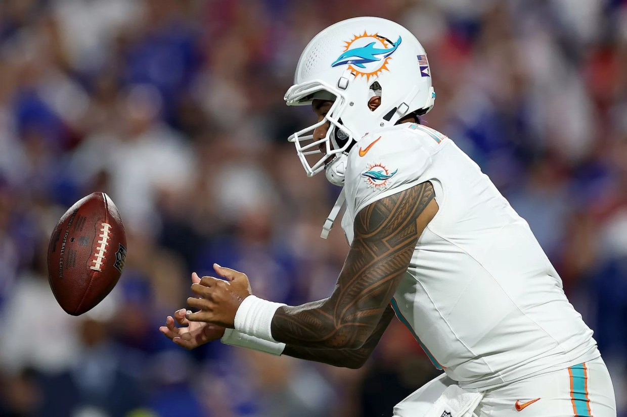 Game photo of Miami Dolphins quarterback receiving a snap from center during the September 18, 2025, game against the Buffalo Bills at Highmark Stadium in Orchard Park, New York.